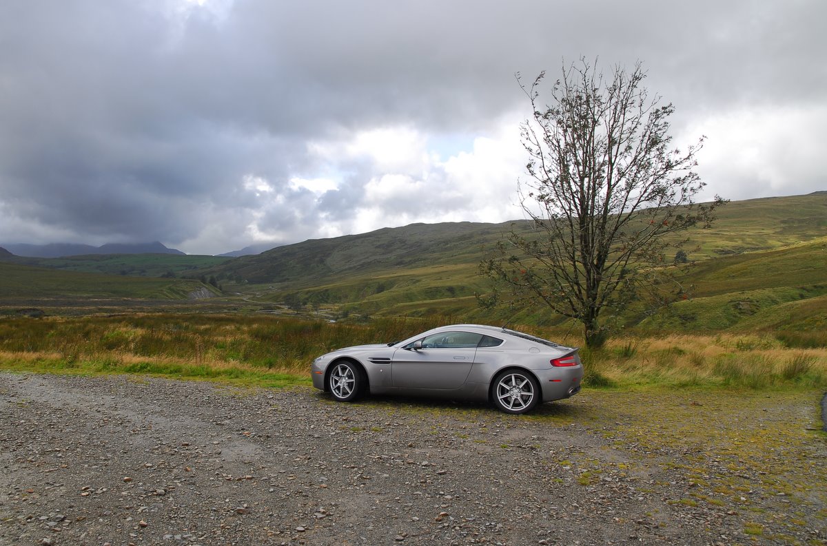 Aston Martin aside the road on a cloudy day